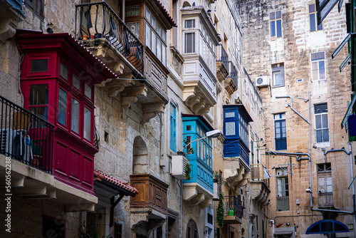 Street with colorful balconies historical part of Valletta the island of Malta