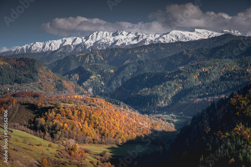 autumn landscape in the mountains, view of the snowy peaks