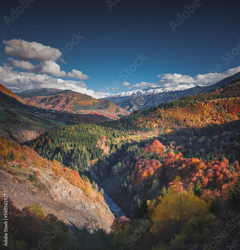 autumn landscape in the mountains, view of the snowy peaks