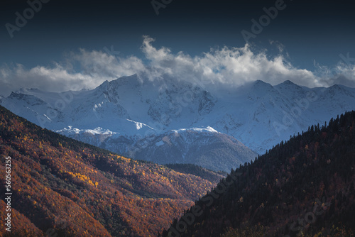 autumn landscape in the mountains, view of the snowy peaks