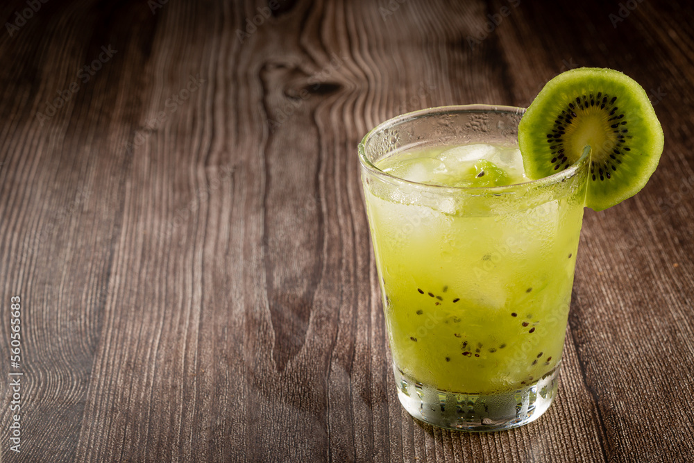 Brazilian Kiwi Caipirinha. Cachaça drink with kiwi, on wooden background. Brazilian Kiwi Caipirinha. Cachaça drink with kiwi, on wooden background.