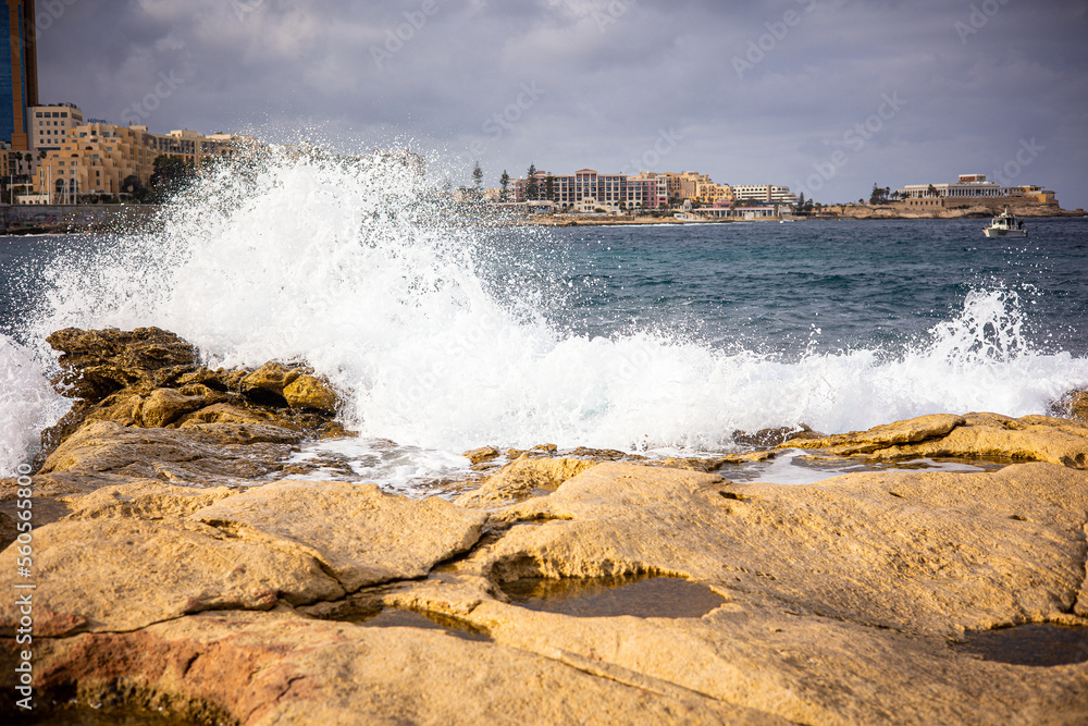 High waves of the ocean on a rocky shore. Coast of the island of Malta in winter
