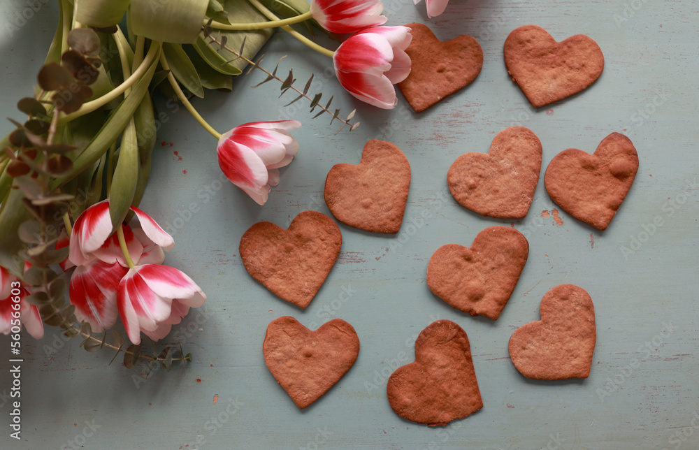 Bouquet of tulips and heart-shaped cookies on the table .Valentines, mothers, womens day, wedding or birthday flat lay concept. Top view. Bouquet of tulips and heart-shaped cookies on the table .Valentines, mothers, womens day, wedding or birthday flat lay concept. Top view.