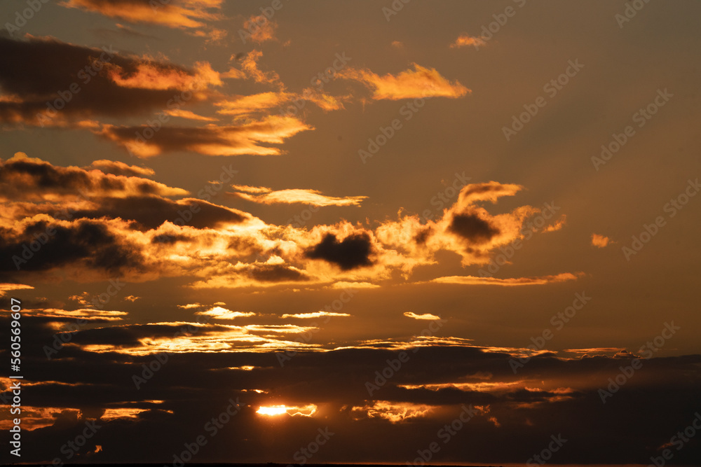 Fototapeta premium Orange sunset clouds with beautiful sun sky scape
