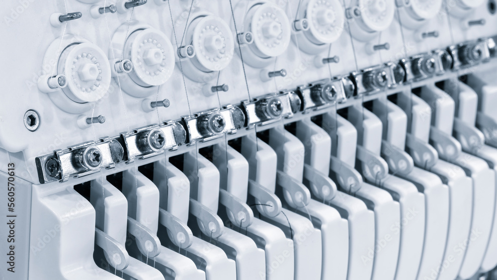 Sewing equipment, loom equipment at a garment factory, industrial concept background Sewing equipment, loom equipment at a garment factory, industrial concept background
