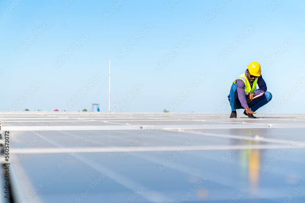 custom made wallpaper toronto digitalAfrican man engineer using digital tablet maintaining solar cell panels on building rooftop. Technician working outdoor on ecological solar farm construction. Renewable clean energy industry concept.