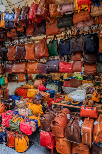 Colorful leather goods at a street stall in Central Market, Florence, Italy