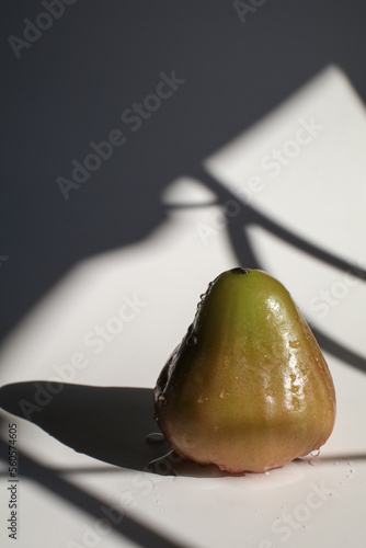 Rose apple or chomphu on white background under morning light from window.. Thailand apple fruit flavors of sweet red gloss. photo