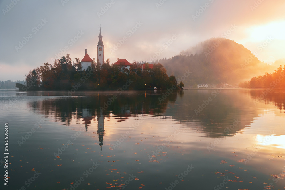 Autumn misty landscape at Lake Bled at sunrise, in the middle of the lake with the church on it, in the Julian Alps, Triglav National Park