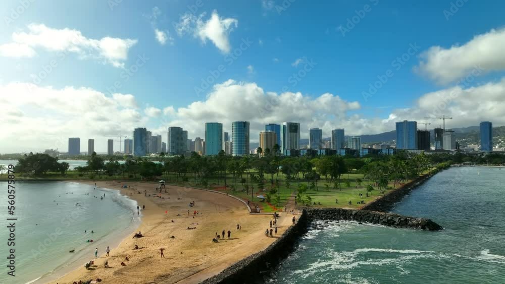 Aerial Beautiful View Of Modern Building Under Clouds, Drone Flying Forward Over People At Beach - Oahu, Hawaii Aerial Beautiful View Of Modern Building Under Clouds, Drone Flying Forward Over People At Beach - Oahu, Hawaii