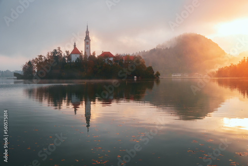 Autumn misty landscape at Lake Bled at sunrise, in the middle of the lake with the church on it, in the Julian Alps, Triglav National Park