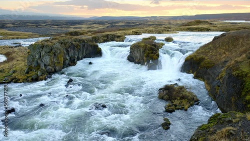 Autumn Waterfall in Iceland. Pure Turquoise Water in Mountain River. Popular Tourist Spot. Famous Travel Destination. Beautiful Nature, Unusual Landscape. Footage Shot in 8K Resolution 4320p photo