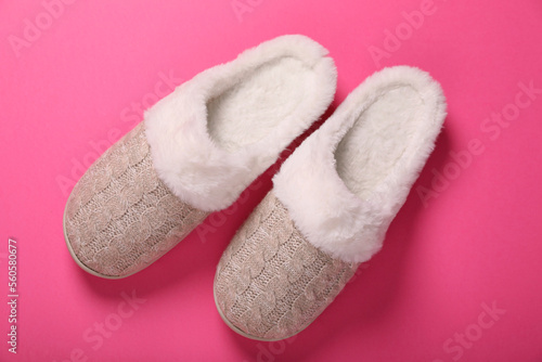 Pair of beautiful soft slippers on pink background, top view