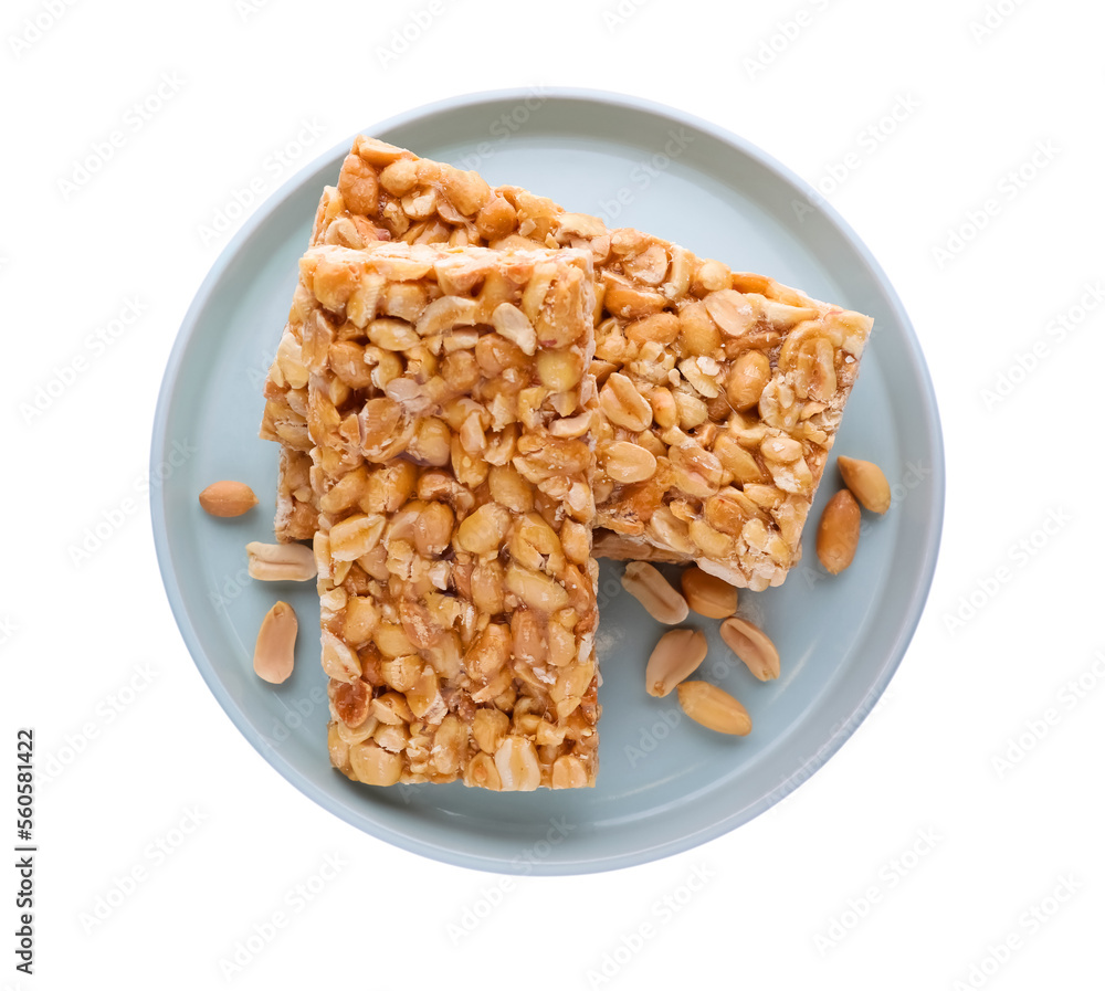 Plate with tasty kozinaki bars and peanuts isolated on white, top view