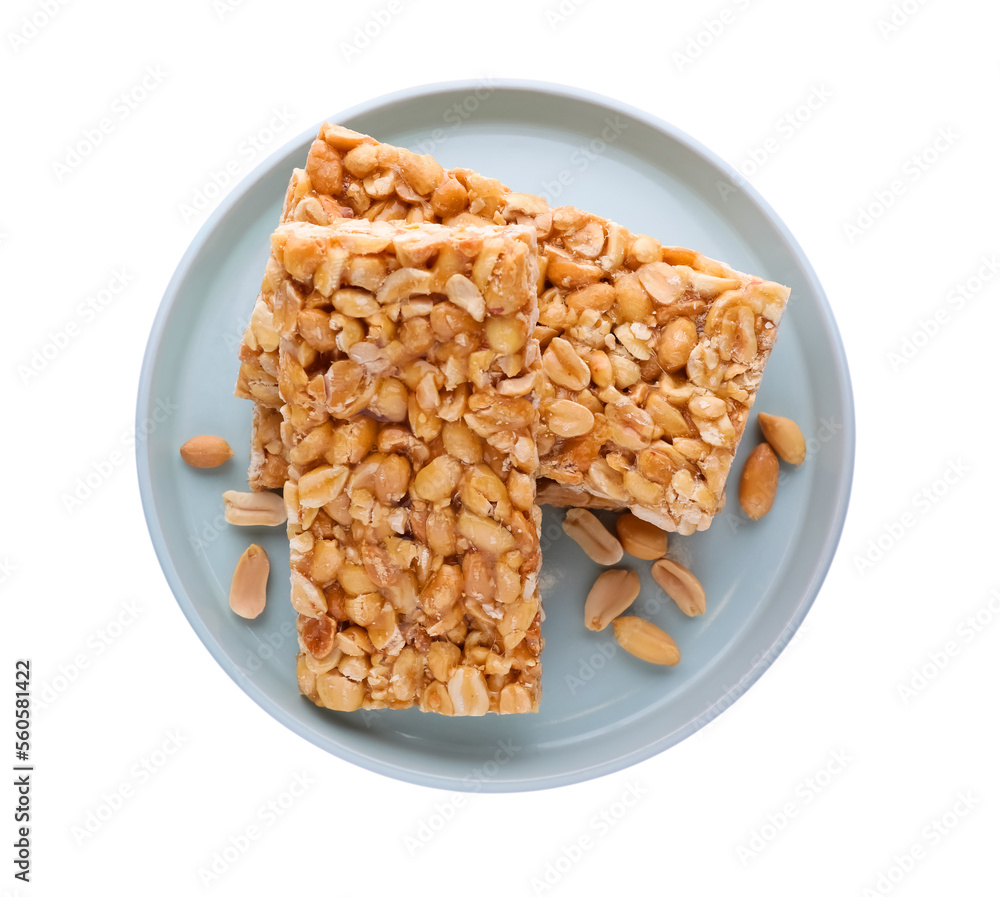 Plate with tasty kozinaki bars and peanuts isolated on white, top view Plate with tasty kozinaki bars and peanuts isolated on white, top view