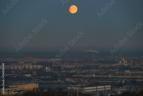 Twilight, moon over the city, panoramic view.