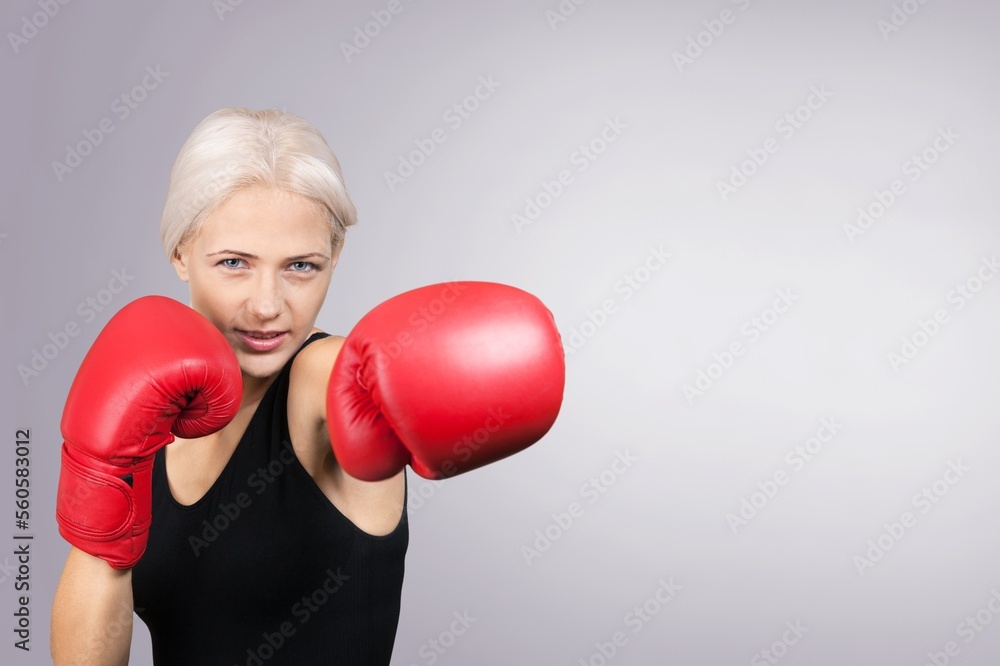 Sporty young woman in boxing gloves Sporty young woman in boxing gloves