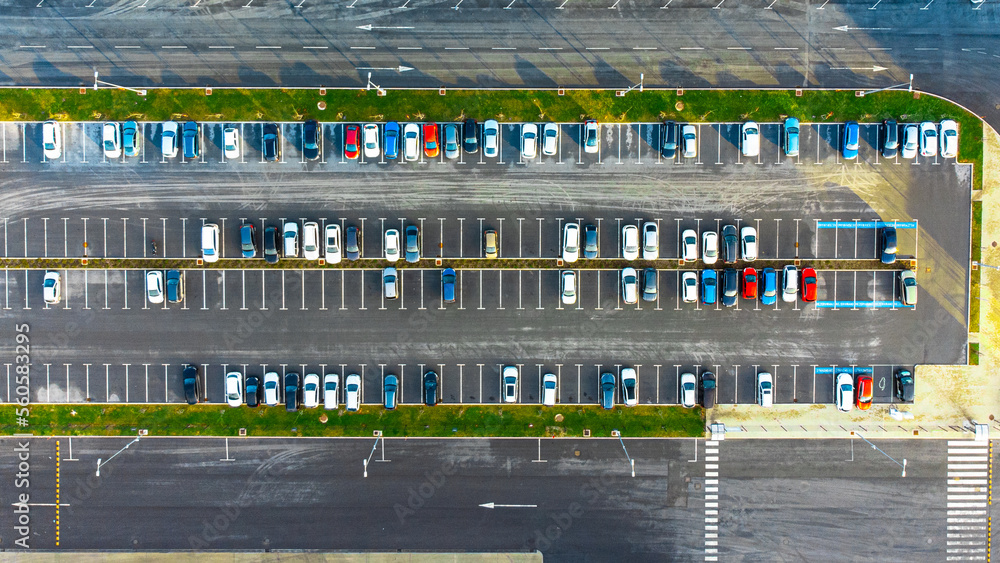 Car park with different color cars and vehicles, top down view