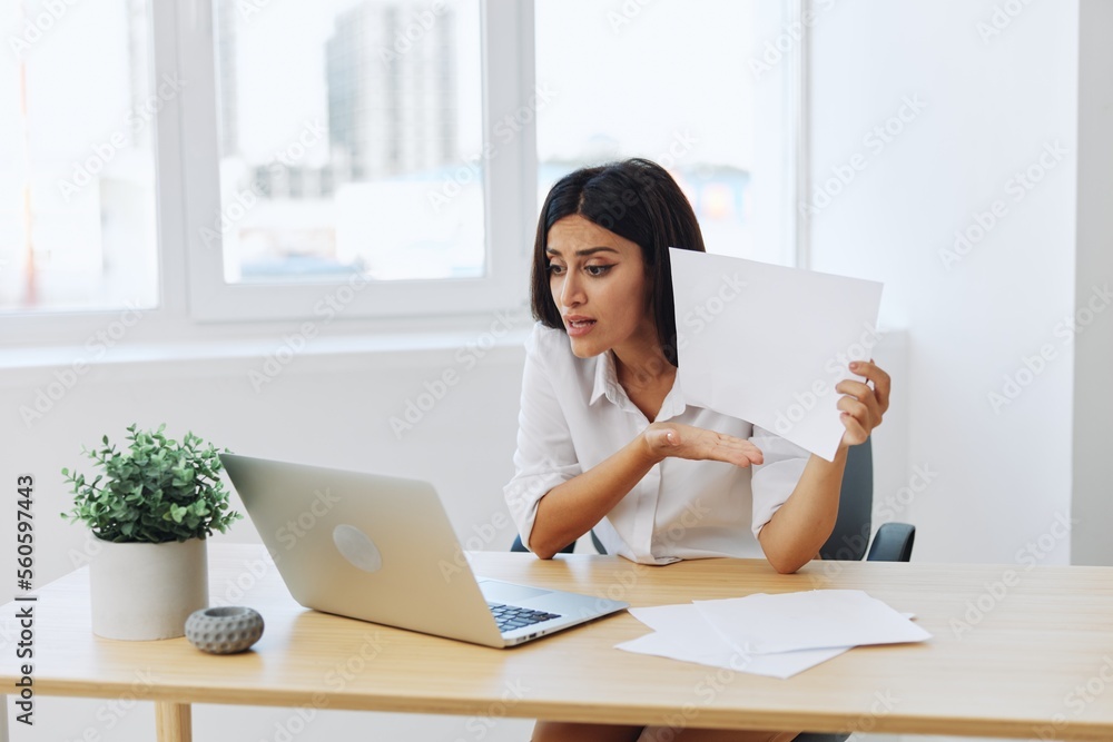 Woman business freelancer over video link via laptop shows papers online for startup, anger and aggression in chat