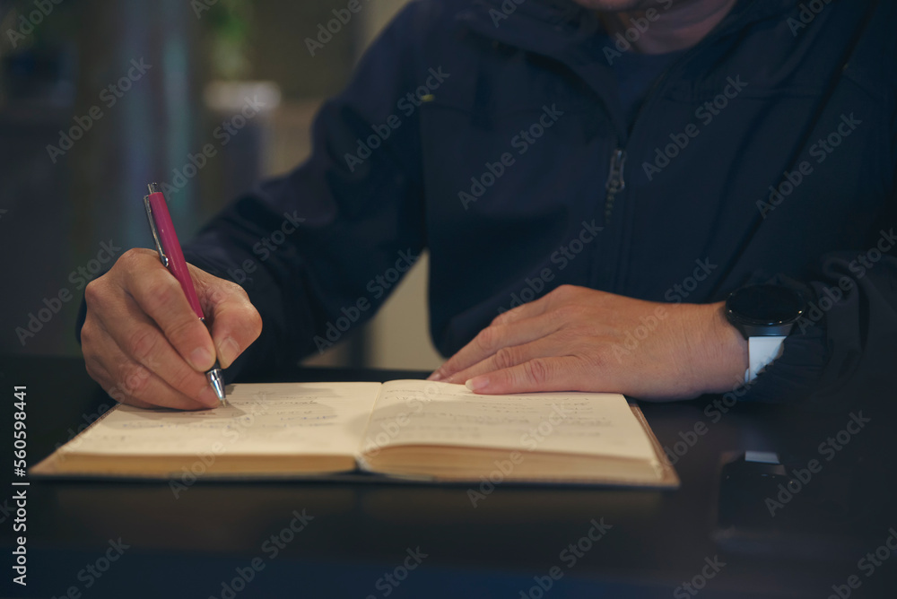 Male hand of planner writing daily appointment On Calendar book, working space at home. Man plan and noted schedule (holiday trip) on diary at office desk. Planner concept. Male hand of planner writing daily appointment On Calendar book, working space at home. Man plan and noted schedule (holiday trip) on diary at office desk. Planner concept.