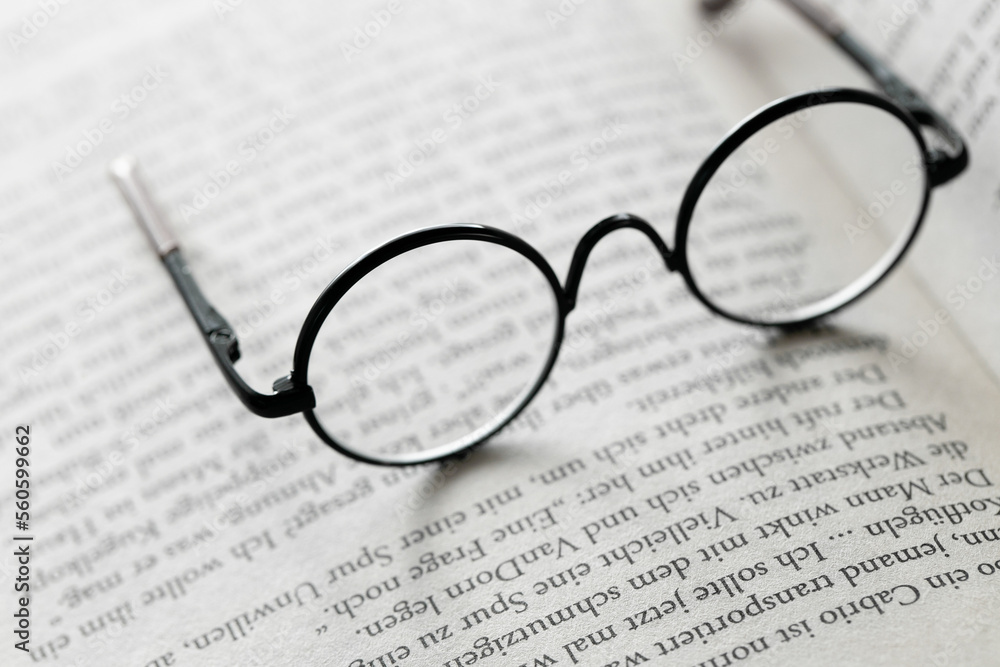 Reading concept.Education and schooling concept.Reading glasses on the pages of a book .Symbol of study, knowledge and reading. Reading concept.Education and schooling concept.Reading glasses on the pages of a book .Symbol of study, knowledge and reading.