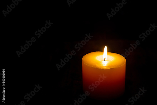 A light of a candle in a dark room with blank for copy space.