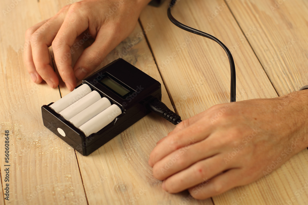 Fotografie charger with batteries on the table