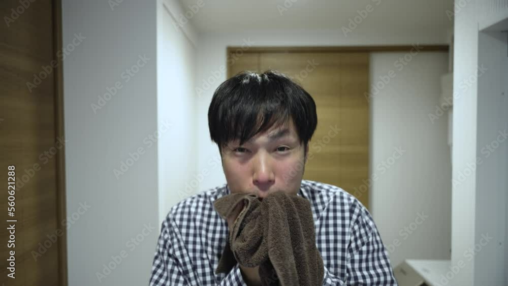 鏡に向かってタオルで拭く男性 鏡に向かってタオルで拭く男性