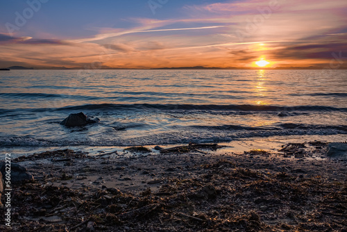 Sunrise over the sea and beautiful cloudscape. Colorful ocean beach sunrise with deep blue sky and sunrays Sunset  beach