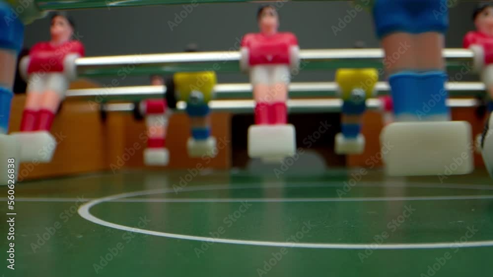 Playing table football, a table-top game. Playing soccer football table in the home Playing table football, a table-top game. Playing soccer football table in the home