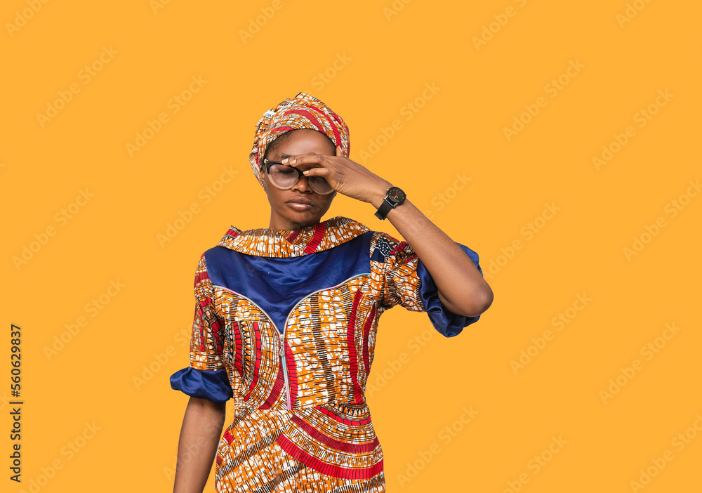 traditionally dressed young african woman with a fatique expression traditionally dressed young african woman with a fatique expression
