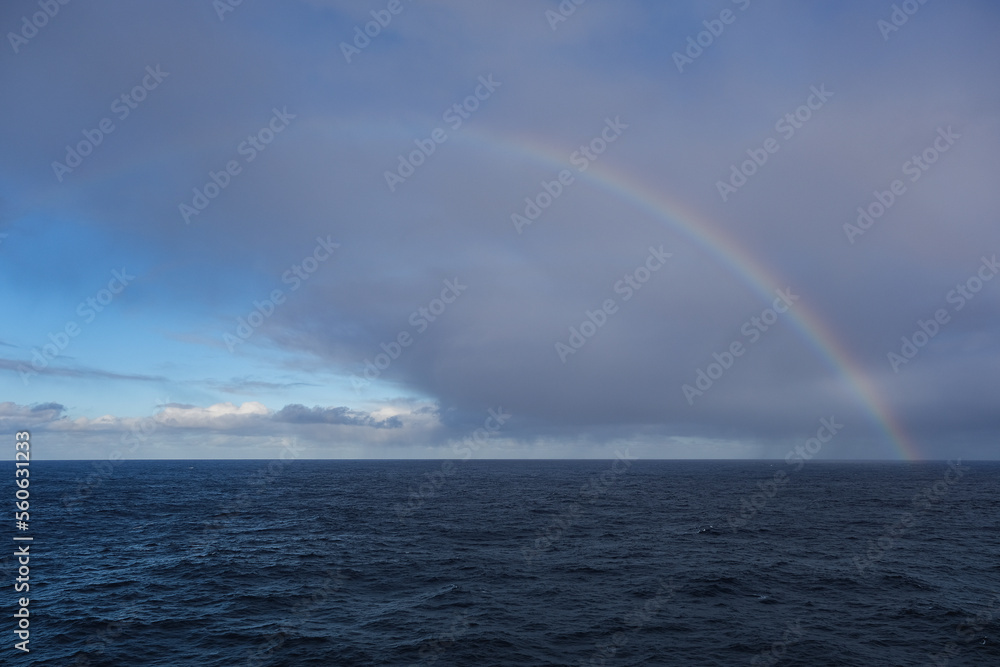 Rainbow at sea after storm during transatlantic passage on legendary ocean liner cruiseship cruise ship on Atlantic Ocean with cloud and seascape