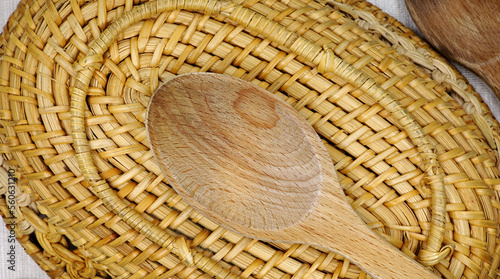 wooden spoon on wicker basket 