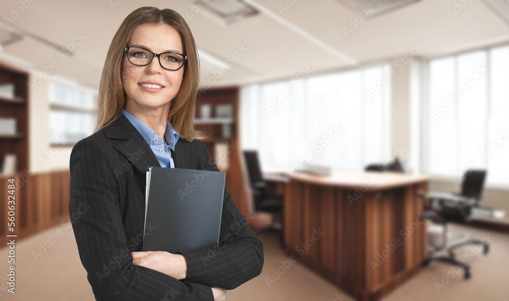 Powerful toung business woman standing in office Powerful toung business woman standing in office
