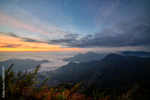 Dramatic sky with fog  in early morning over the mountain at Phu Chee Fah in Thailand