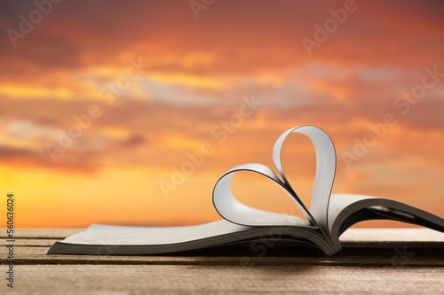 Love concept. Open reading book an pages in heart form
