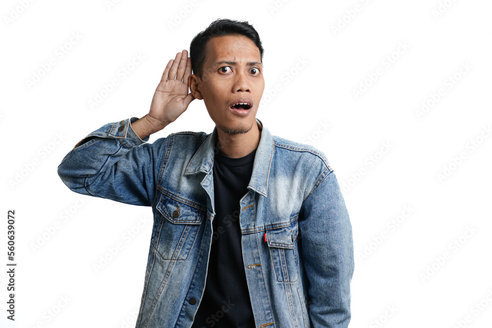 Asian man wearing blue jean jacket expression surprised hearing something. Hand on ear, isolated on white background Asian man wearing blue jean jacket expression surprised hearing something. Hand on ear, isolated on white background