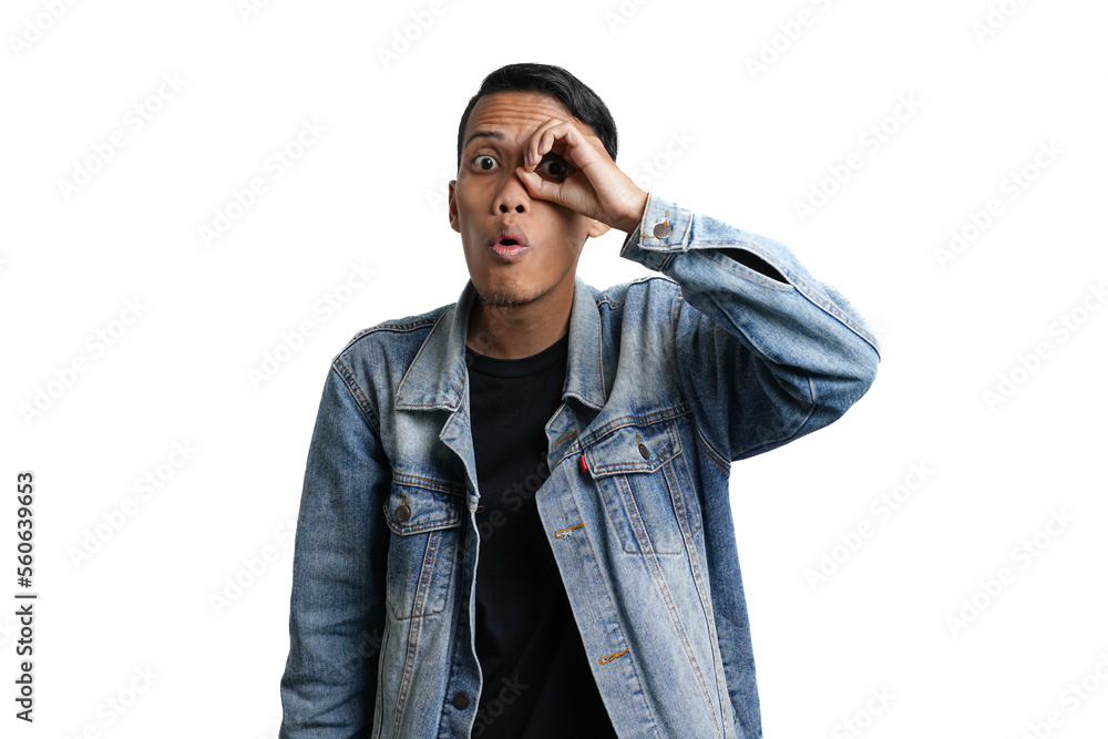 Asian man wearing blue jean jacket showing ok symbol finger watching eye binoculars. Isolated by white background Asian man wearing blue jean jacket showing ok symbol finger watching eye binoculars. Isolated by white background