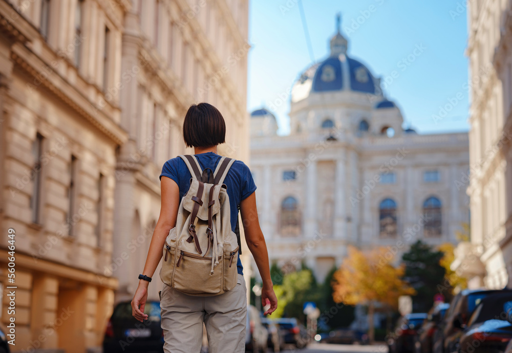 summer female solo trip to Europe, happy young woman walking on european street of Vienna, Austria summer female solo trip to Europe, happy young woman walking on european street of Vienna, Austria