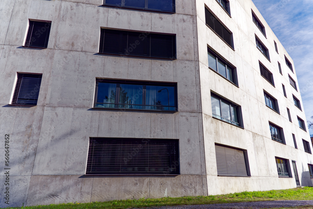 Gray concrete facade of modern residential building at City of Zürich on a sunny autumn day. Photo taken November 21st, 2022, Zurich, Switzerland. Gray concrete facade of modern residential building at City of Zürich on a sunny autumn day. Photo taken November 21st, 2022, Zurich, Switzerland.