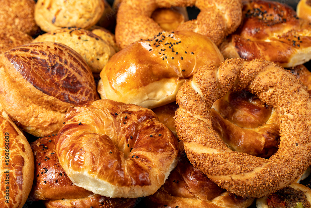 Bagel and pogaca varieties. They eat pastries in piles. Bakery products. Traditional turkish cuisine breakfast culture. Local name simit, pogaca, borek, acma. close up - obrazy, fototapety, plakaty 