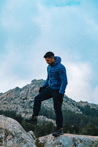 young traveler stands in front of a mountains
