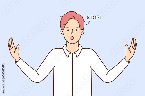 Decisive young man show stop gesture 