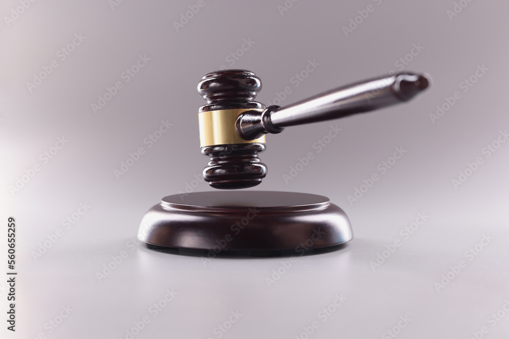 Brown wooden judge gavel in air closeup Brown wooden judge gavel in air closeup