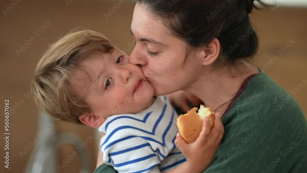 Affectionate mother kissing little boy son in cheek. Parenting family happiness concept. Mom embracing and hugging child. Candid lifestyle Affectionate mother kissing little boy son in cheek. Parenting family happiness concept. Mom embracing and hugging child. Candid lifestyle