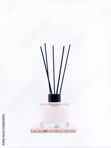 Wooden aroma sticks in a glass flask filled with flavor liquid substance isolated over white background, side view