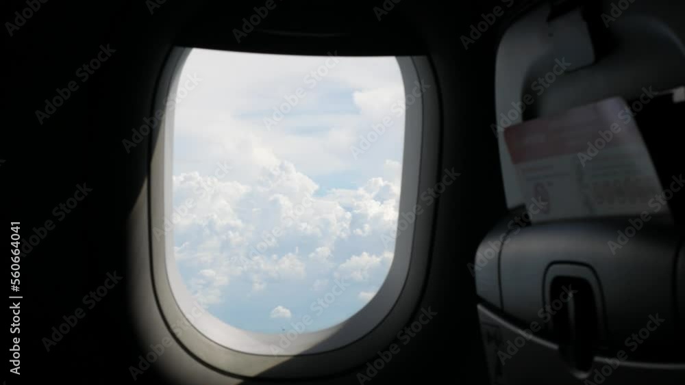 view through the plane window with thick cloud above the beautiful sky, clouds over sea ocean coast landscape view through the plane window with thick cloud above the beautiful sky, clouds over sea ocean coast landscape