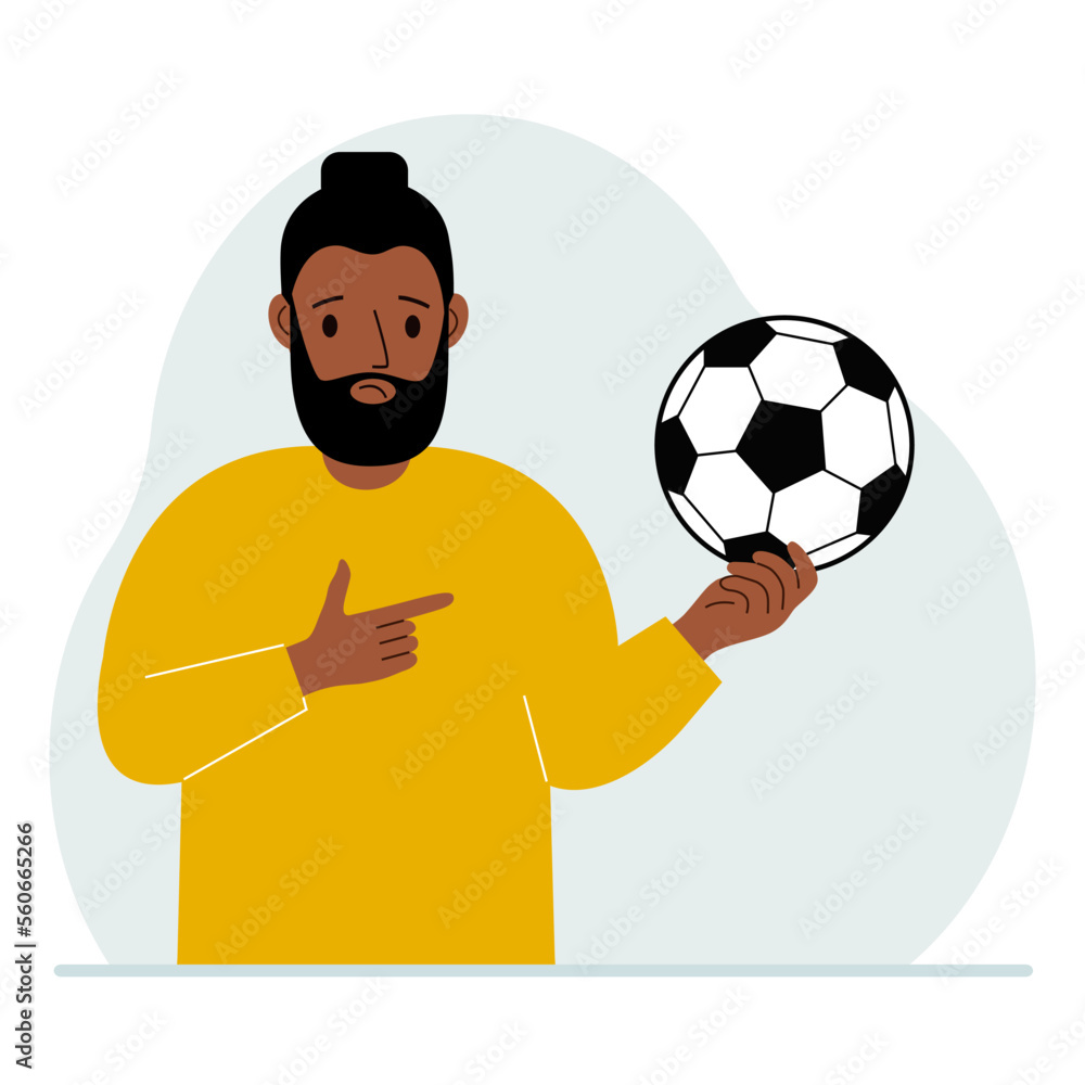 A man holds a soccer ball in his hand. The concept of a player, fan or coach.
