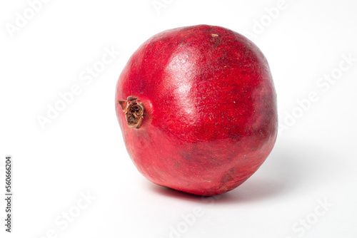 Whole fresh ripe pomegranate on white background.