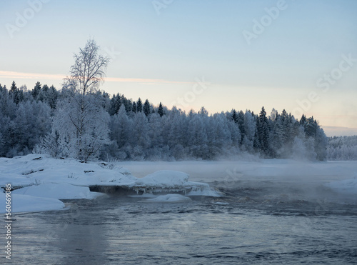 Strong frost in January on the Shuya River in the Republic of Karelia, northwestern Russia.
Steam over water. The waterfall in the river is partially frozen.